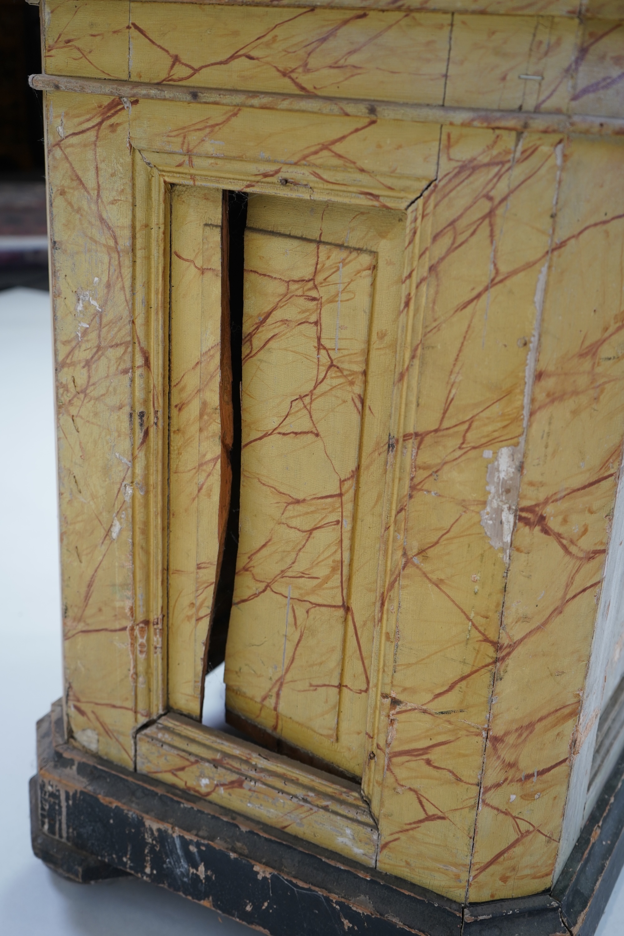 A Victorian white painted cast iron urn and a painted faux marble pedestal